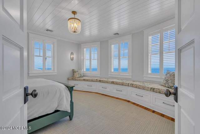 bedroom featuring light hardwood / wood-style floors, an inviting chandelier, crown molding, and wood ceiling