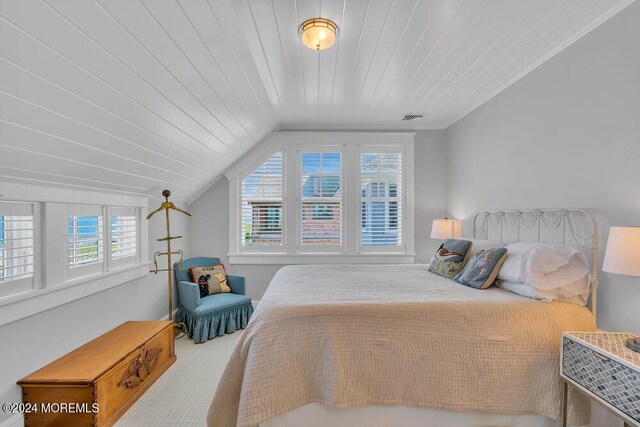 bedroom featuring lofted ceiling, multiple windows, and wooden ceiling