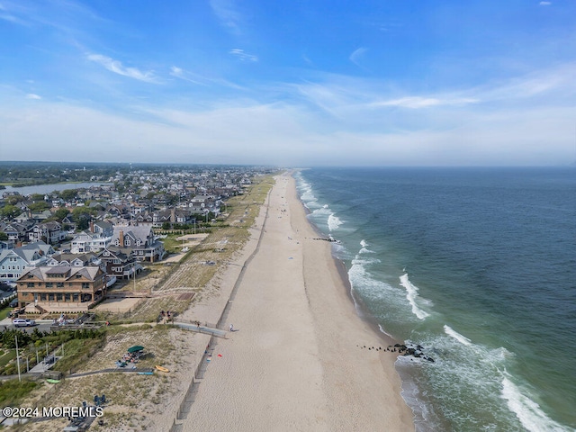 birds eye view of property featuring a view of the beach and a water view