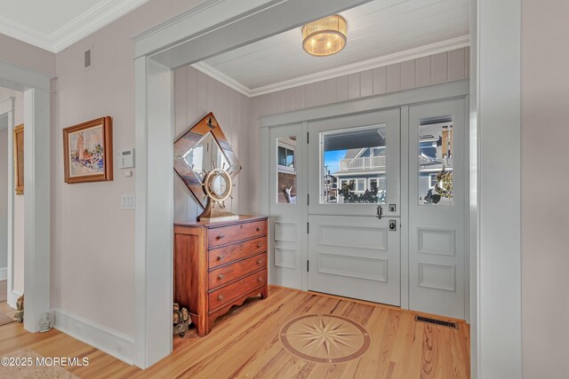 entrance foyer with crown molding and hardwood / wood-style flooring