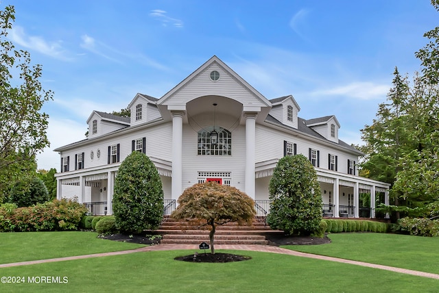 view of front of property featuring a front lawn and covered porch