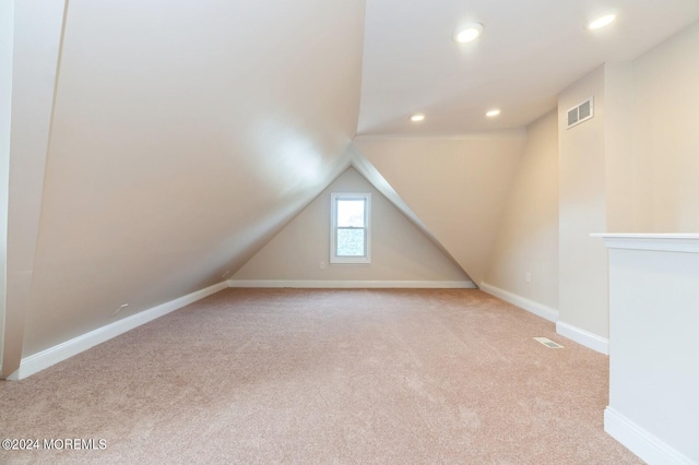 additional living space with light carpet and lofted ceiling