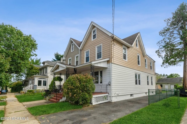 view of property featuring a front yard and a porch