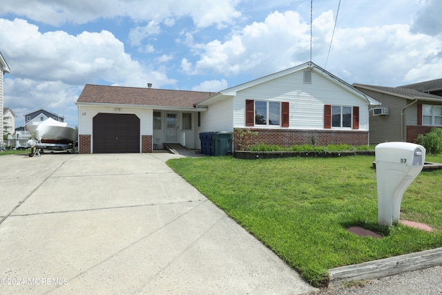 single story home with a garage, a front yard, and a wall unit AC