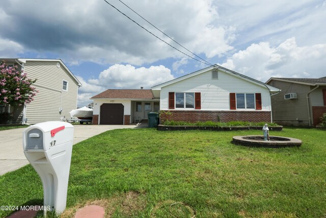 view of front of house featuring a garage and a front yard