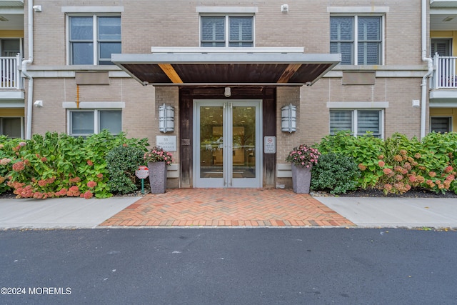 property entrance featuring french doors and a balcony