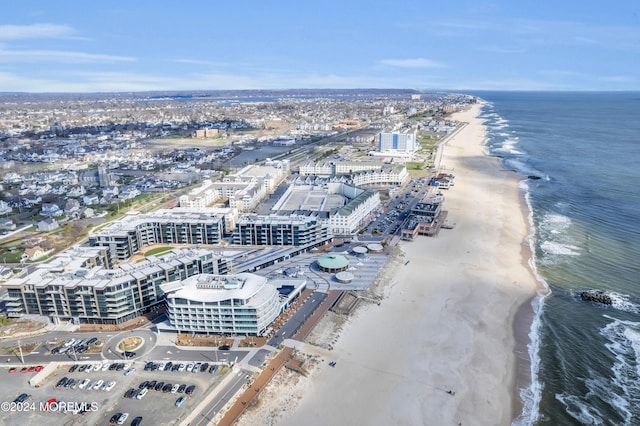 birds eye view of property with a water view and a view of the beach