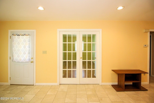 entryway featuring french doors and light tile patterned flooring