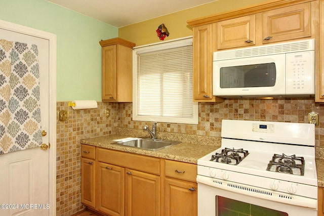 kitchen featuring white appliances and sink