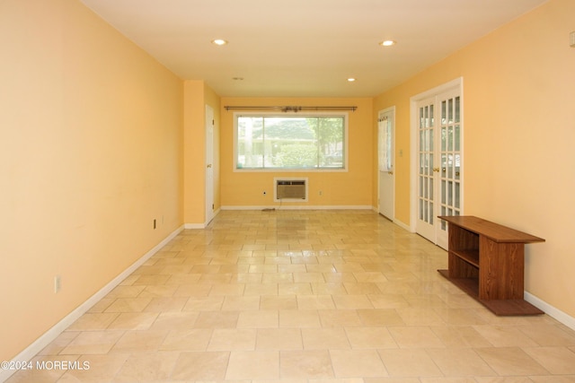 spare room with french doors and a wall mounted AC