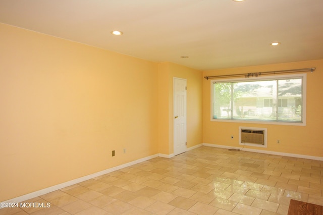 tiled spare room with an AC wall unit