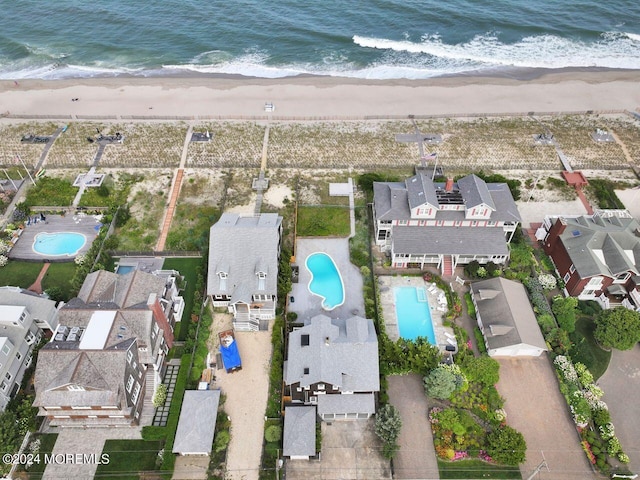 bird's eye view featuring a view of the beach and a water view