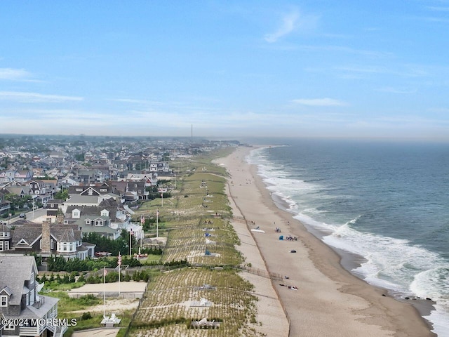 bird's eye view featuring a water view and a beach view