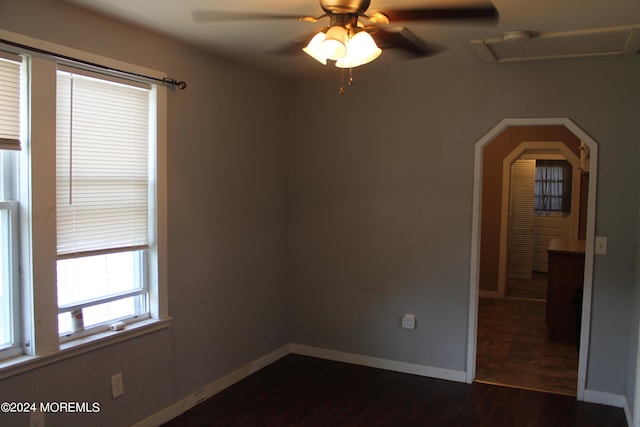 empty room with dark wood-type flooring and ceiling fan