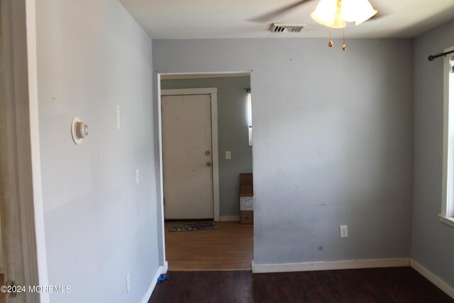 spare room featuring ceiling fan and dark wood-type flooring