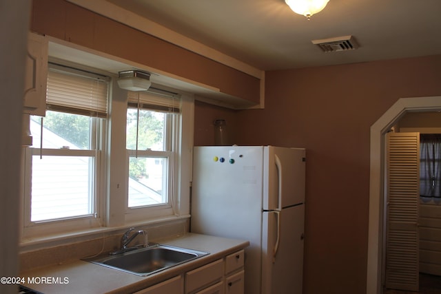 kitchen featuring white fridge and sink