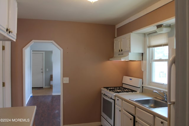 kitchen with sink, white appliances, dark hardwood / wood-style floors, and white cabinets