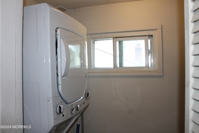 bathroom with stacked washer and clothes dryer