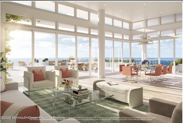 sunroom with a chandelier and a water view