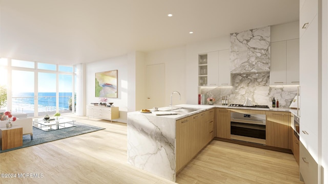 390 Ocean Ave Unit 2707, Long Branch, NJ 07740 - kitchen with appliances with stainless steel finishes, a sink, a peninsula, modern cabinets, and backsplash