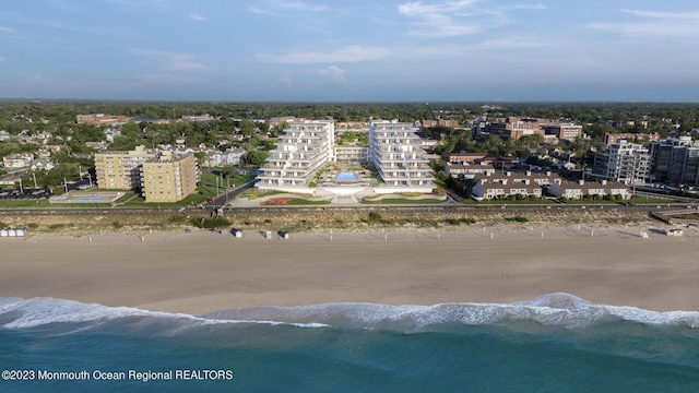 aerial view with a water view and a view of the beach