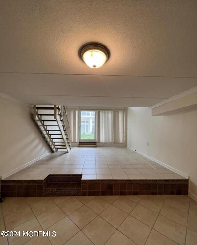 interior space with tile patterned floors and a textured ceiling