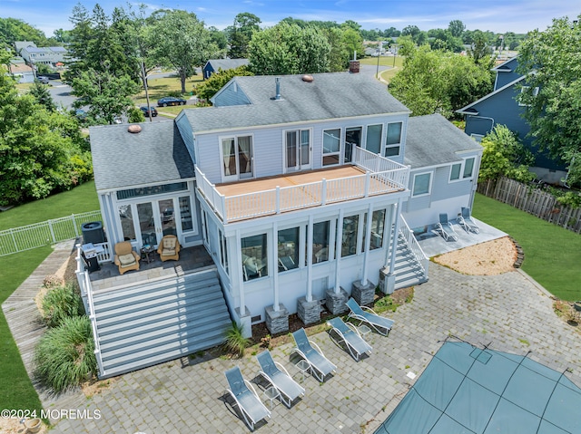 back of property with a patio, a balcony, a lawn, and cooling unit