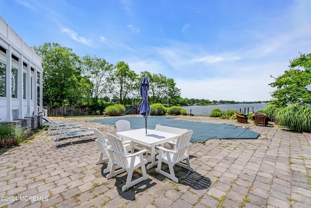 view of patio / terrace with a water view and a covered pool