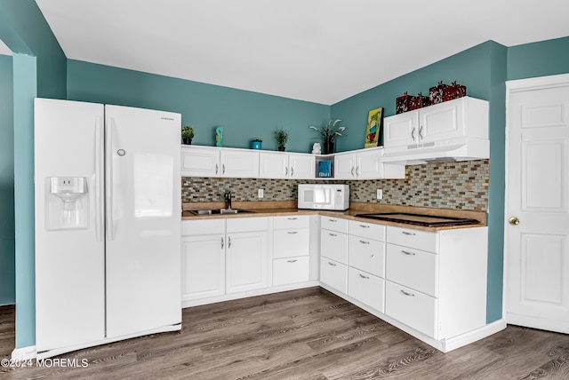 kitchen with sink, white appliances, hardwood / wood-style floors, backsplash, and white cabinets