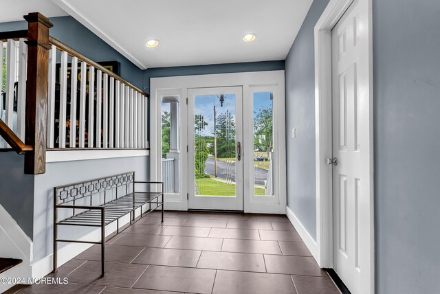 doorway with dark tile patterned floors