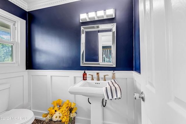 bathroom with ornamental molding and toilet