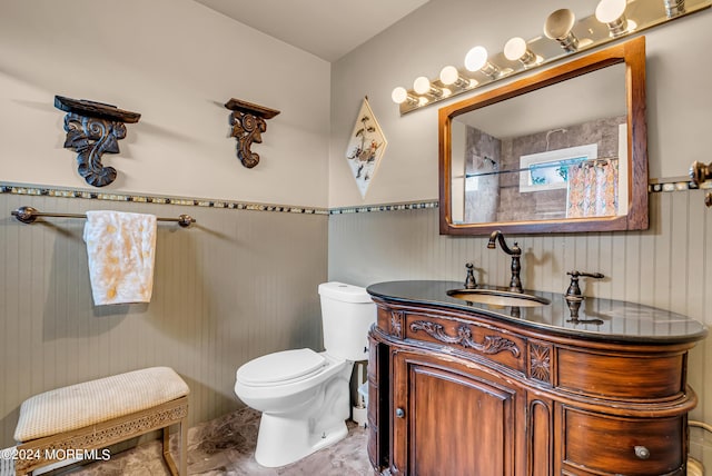 bathroom featuring vanity, curtained shower, and toilet