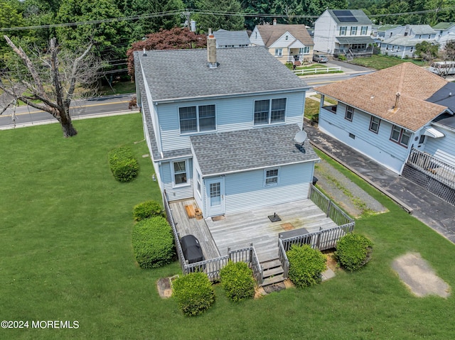 rear view of property with a yard and a deck