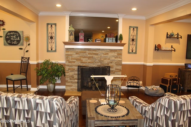 living room with ornate columns, ornamental molding, hardwood / wood-style floors, and a fireplace