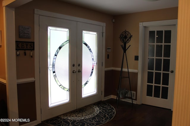 foyer entrance featuring dark hardwood / wood-style floors and french doors