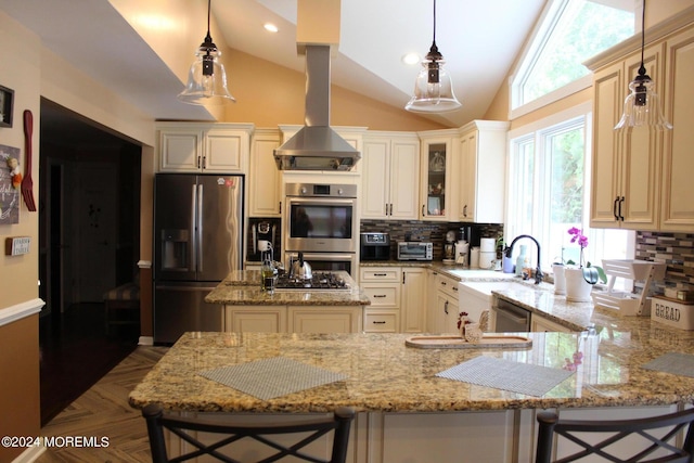 kitchen featuring a breakfast bar, hanging light fixtures, backsplash, stainless steel appliances, and light stone counters