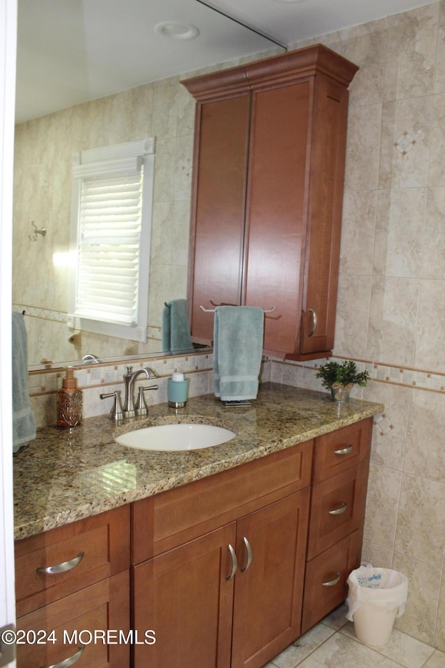 bathroom featuring tile patterned floors, tile walls, and vanity