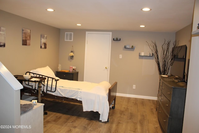 bedroom with wood-type flooring