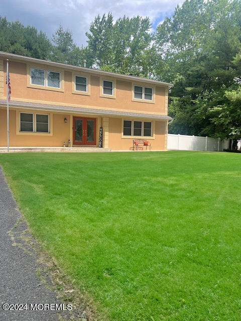 view of front of property with a front yard and french doors