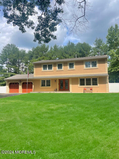 view of front of home with a garage and a front yard