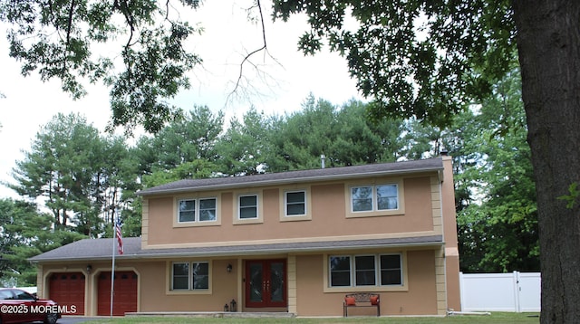 view of front of home with a garage and a front yard