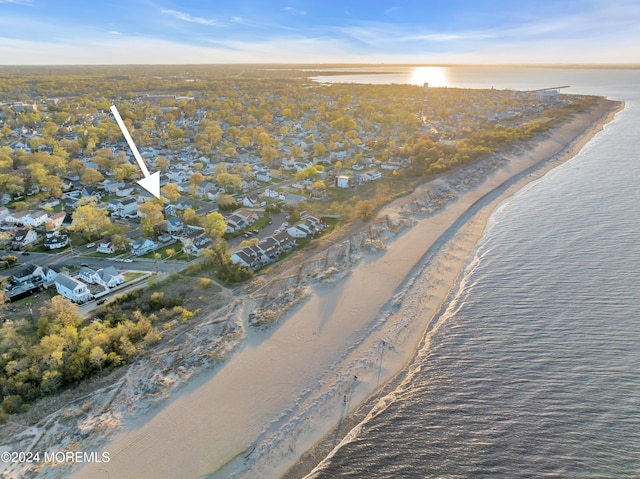 aerial view with a water view and a beach view