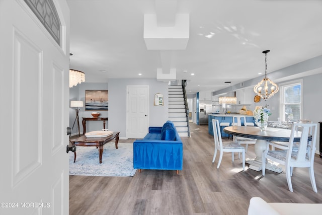 living room featuring hardwood / wood-style floors and a notable chandelier