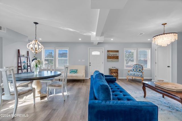 living room featuring hardwood / wood-style floors, an inviting chandelier, and plenty of natural light