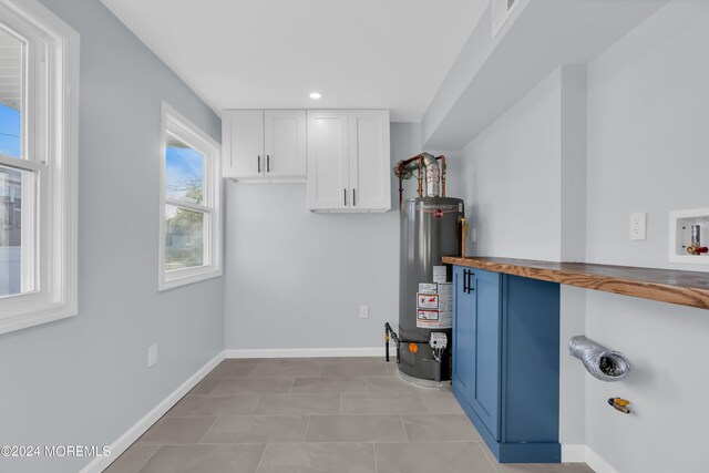 utility room featuring gas water heater