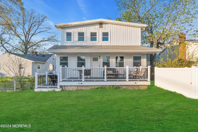 rear view of property featuring a yard