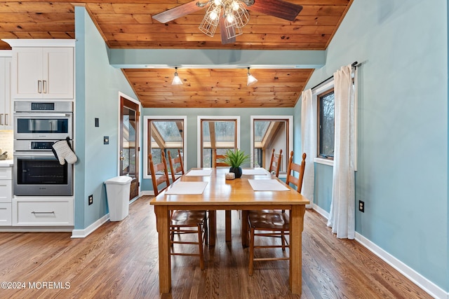 dining room with wooden ceiling, hardwood / wood-style floors, lofted ceiling with beams, and track lighting