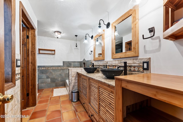 bathroom featuring tile patterned flooring, vanity, and tile walls