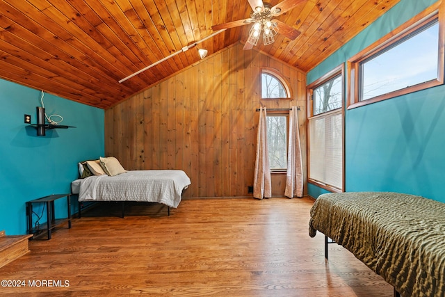 bedroom with lofted ceiling, ceiling fan, light wood-type flooring, and wooden ceiling