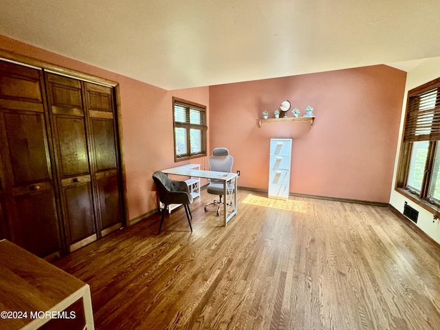 office space with lofted ceiling and light hardwood / wood-style flooring